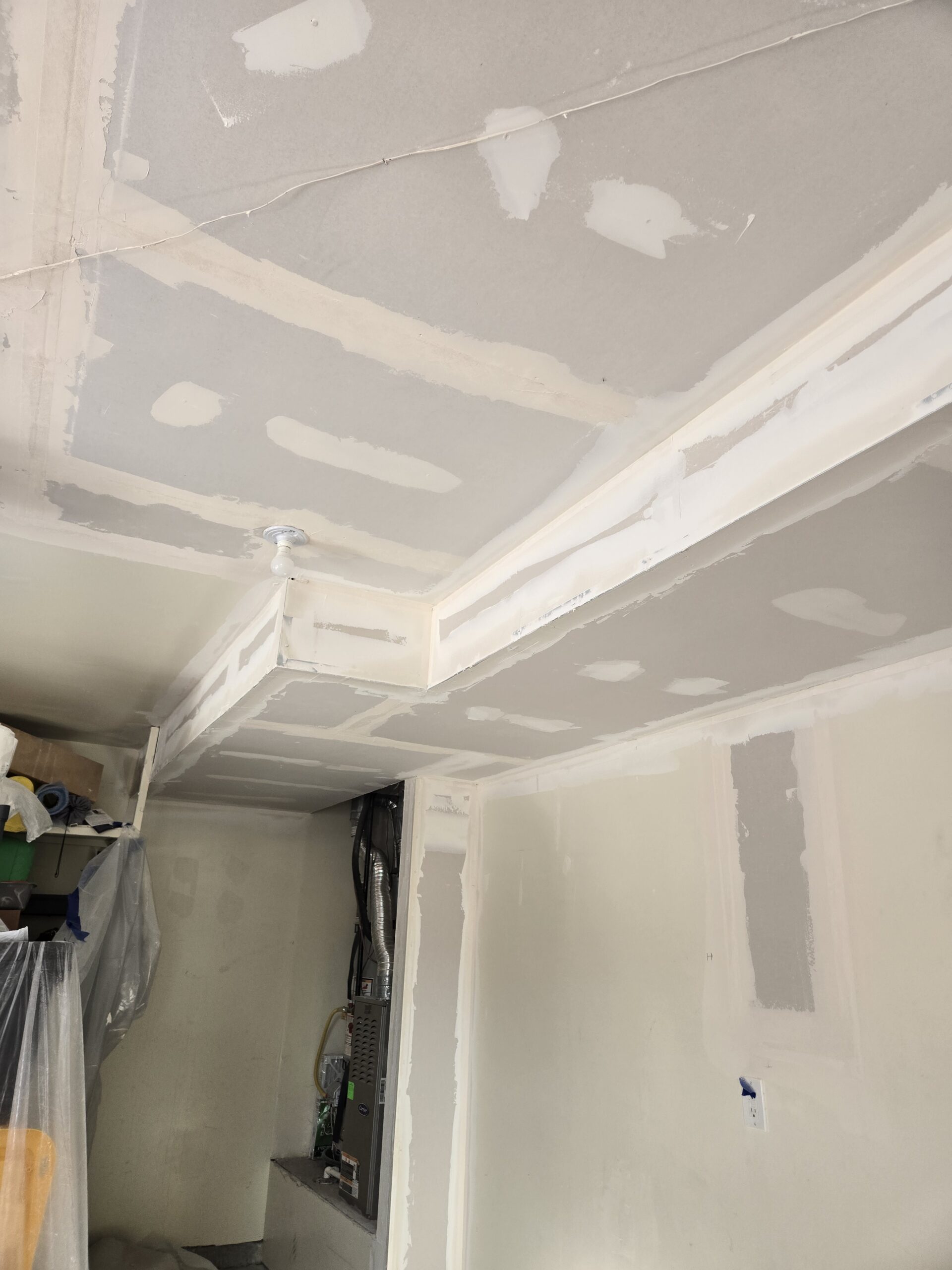 Freshly taped and mudded drywall seams before finishing