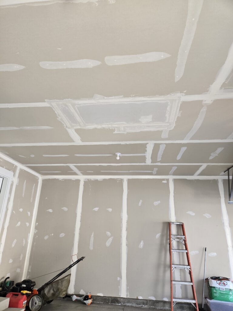 Large ceiling drywall patch and professional taping in a residential garage, performed by The Drywall Doctor in Pleasant View, Utah.