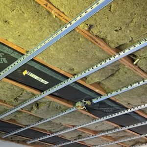 Soundproof ceiling resilient channels and Rockwool insulation Resilient channels and Rockwool insulation installed for a soundproof ceiling system.